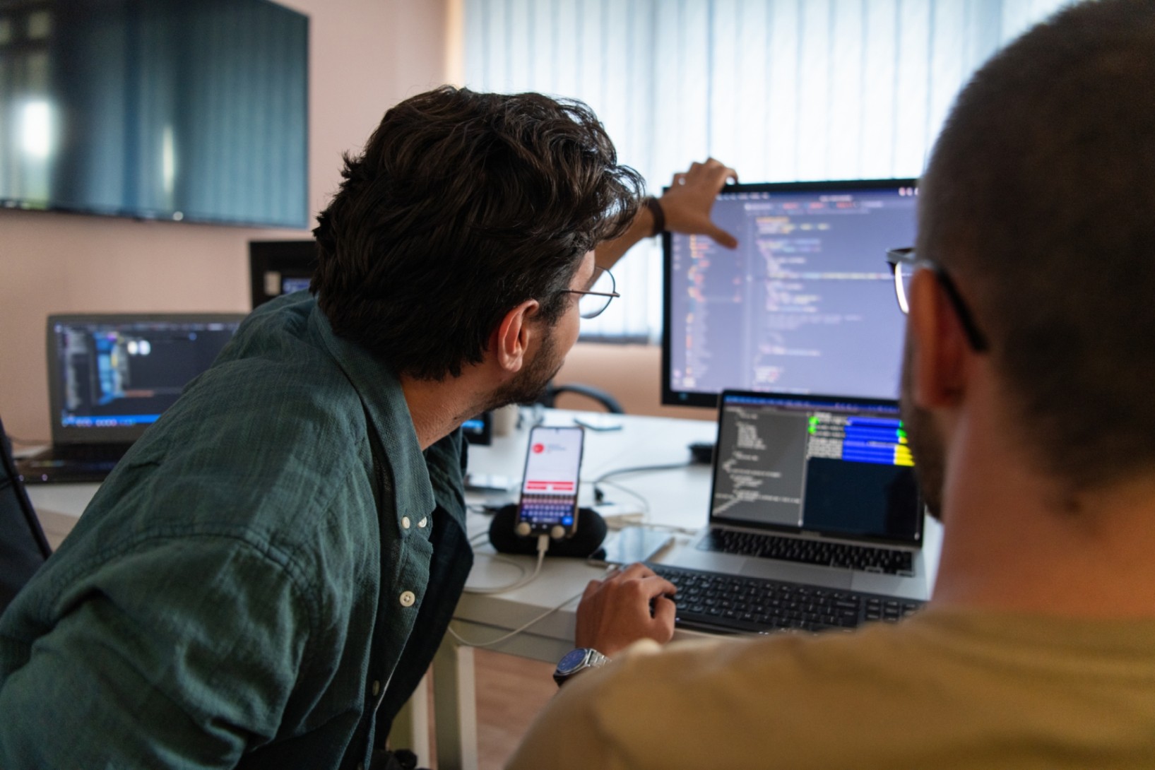 Two people looking at a monitor