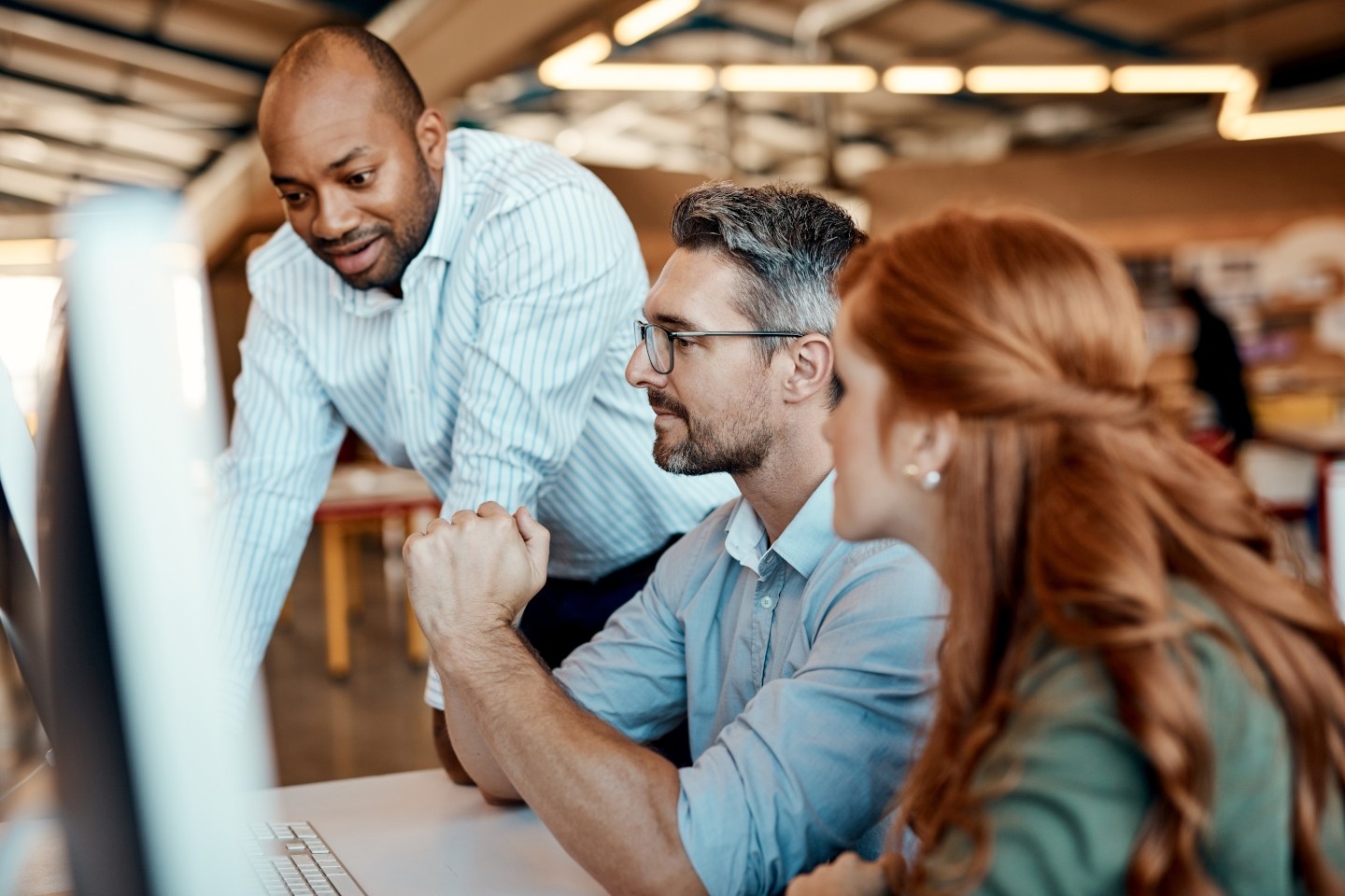 People looking at a screen in business setting
