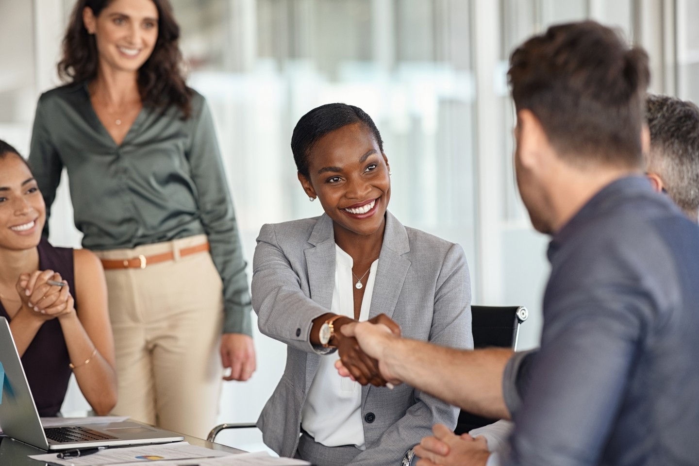 People shaking hands in business setting